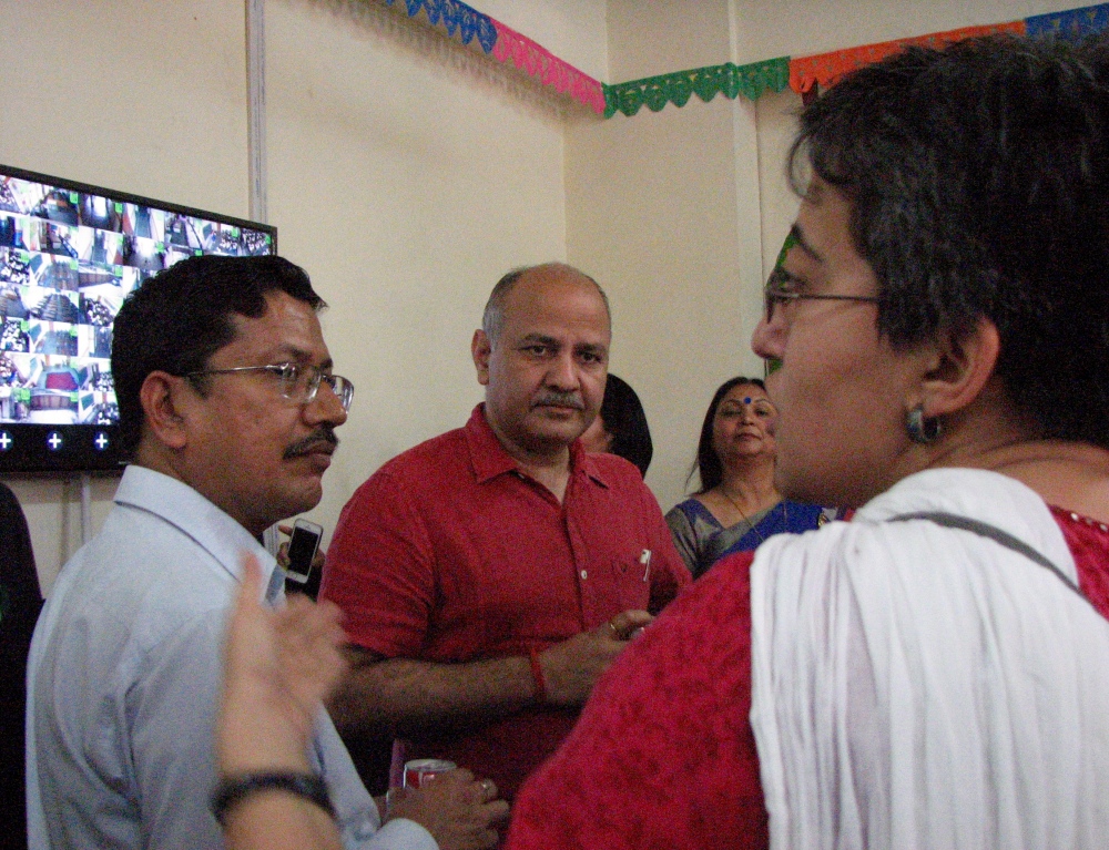 Delhi Education Minister Manish Sisodia, with his advisor Atishi Marlena, discusses CCTV footage being shown on a large screen from the various classrooms of the Government Boys Senior Secondary School, Shahbad Daulatpur, North Delhi. (Photo credit: Aparna Kalra) Delhi Education Minister Manish Sisodia, with his advisor Atishi Marlena, discusses CCTV footage being shown on a large screen from the various classrooms of the Government Boys Senior Secondary School, Shahbad Daulatpur, North Delhi. (Photo credit: Aparna Kalra)
