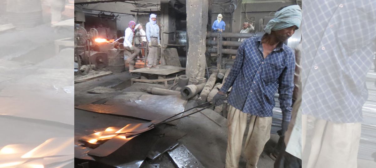 In the steel mills of Delhi, as the heat sizzles, workers faint