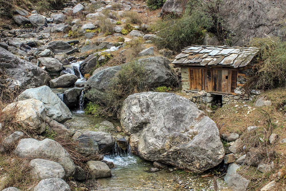 View of a typical gharat or kuhl driven water mill for grinding wheat and spices. Photo credit: Sumit Mahar (Himdhara Collective). View of a typical gharat or kuhl driven water mill for grinding wheat and spices. Photo credit: Sumit Mahar (Himdhara Collective).