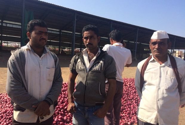 Onion farmer Deepak Patil (centre) has a bank account, a cell phone, and accepts payments in cheque. Patil could, in theory, move to cashless transactions, but in reality there is no Internet access where he lives, the closest ATM is at least 25 km away, the closest nationalised bank 15 km away, and the government has currently placed restrictions on the district cooperative bank that hosts his account. Image Credit: India Spend/Swagata Yadavar Onion farmer Deepak Patil (centre) has a bank account, a cell phone, and accepts payments in cheque. Patil could, in theory, move to cashless transactions, but in reality there is no Internet access where he lives, the closest ATM is at least 25 km away, the closest nationalised bank 15 km away, and the government has currently placed restrictions on the district cooperative bank that hosts his account. Image Credit: India Spend/Swagata Yadavar