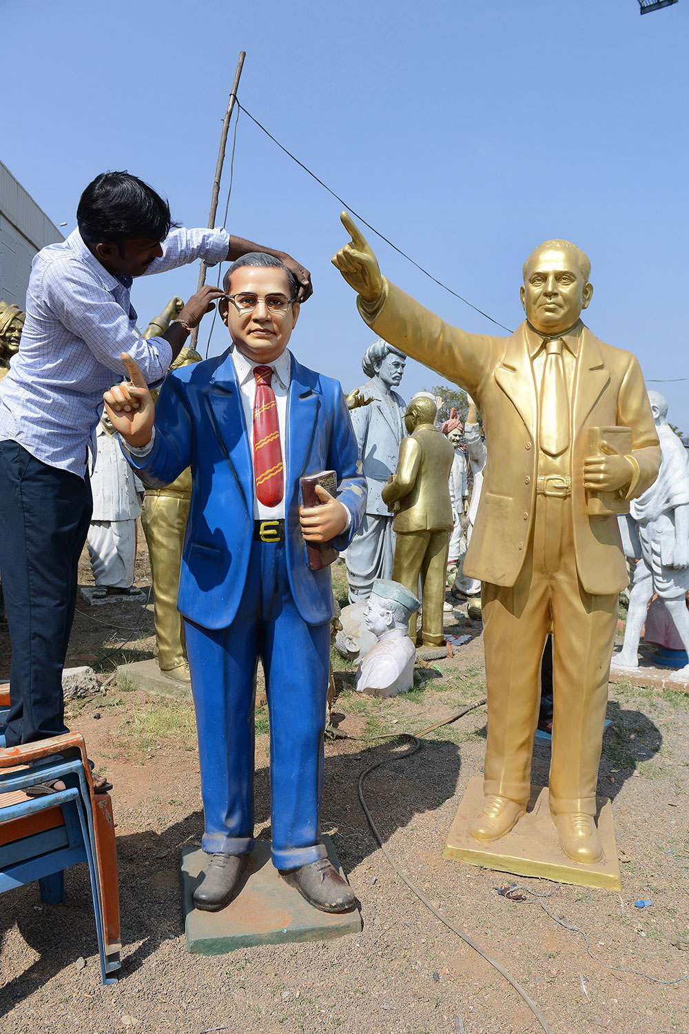 An artist fixes spectacles onto a statue of BR Ambedkar at his workshop on the outskirts of Hyderabad. Photo credit: Noah Seelam/AFP An artist fixes spectacles onto a statue of BR Ambedkar at his workshop on the outskirts of Hyderabad. Photo credit: Noah Seelam/AFP