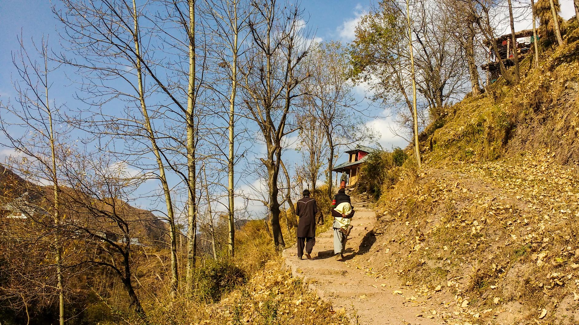 A labourer carrying a PPD-affected person uphill, towards the village. (Photo: Rayan Naqash) A labourer carrying a PPD-affected person uphill, towards the village. (Photo: Rayan Naqash)