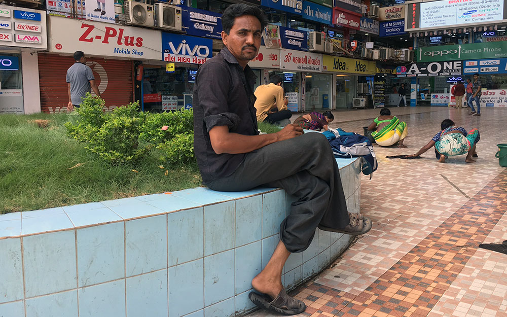 Dinesh Jogadiya is one of the Kathiawadis who moved to Surat when the diamond-polishing industry mechanised. He now sticks diamonds to garments. "A packet of 400 diamonds comes for Rs 40,000. It takes about three minutes to stick diamonds to a sari. We make Rs 3 for every 100 diamonds.” Photo credit: M Rajshekhar Dinesh Jogadiya is one of the Kathiawadis who moved to Surat when the diamond-polishing industry mechanised. He now sticks diamonds to garments. "A packet of 400 diamonds comes for Rs 40,000. It takes about three minutes to stick diamonds to a sari. We make Rs 3 for every 100 diamonds.” Photo credit: M Rajshekhar