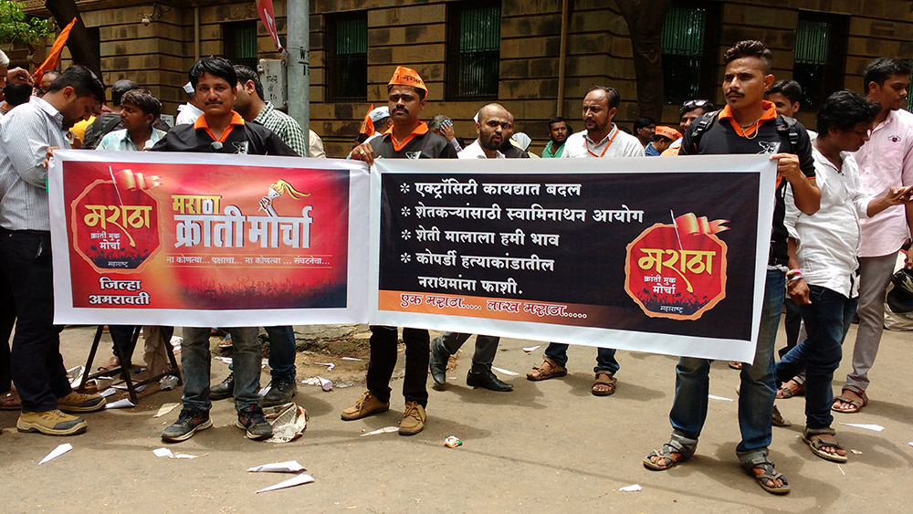 Ashwin Pawar, centre, holds up his group's banner, without the demand for reservation. Photo: Mridula Chari Ashwin Pawar, centre, holds up his group's banner, without the demand for reservation. Photo: Mridula Chari