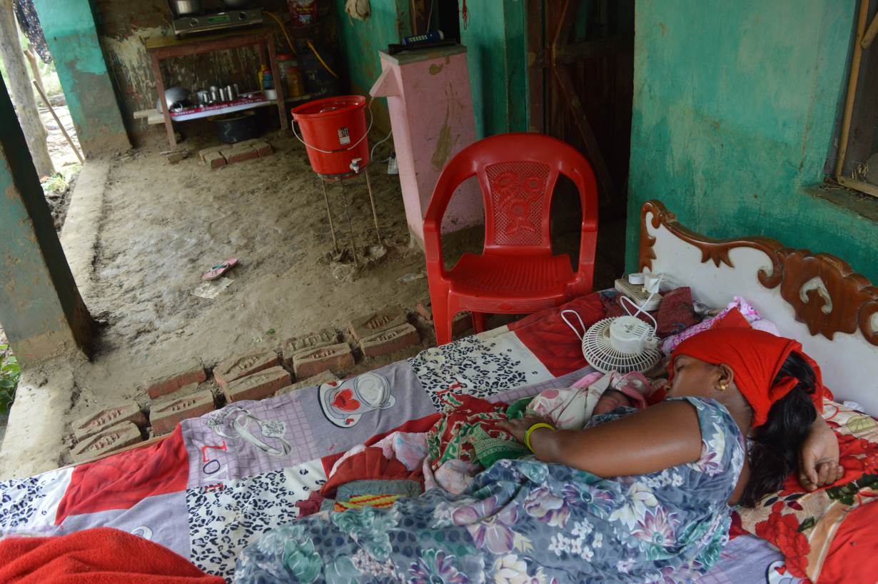Shreejana Pariyar lies with her newborn on a bed on her front porch in Taduwa, Nepal, August 16. Photo credit: Arun Karki/Thomson Reuters Foundation Shreejana Pariyar lies with her newborn on a bed on her front porch in Taduwa, Nepal, August 16. Photo credit: Arun Karki/Thomson Reuters Foundation
