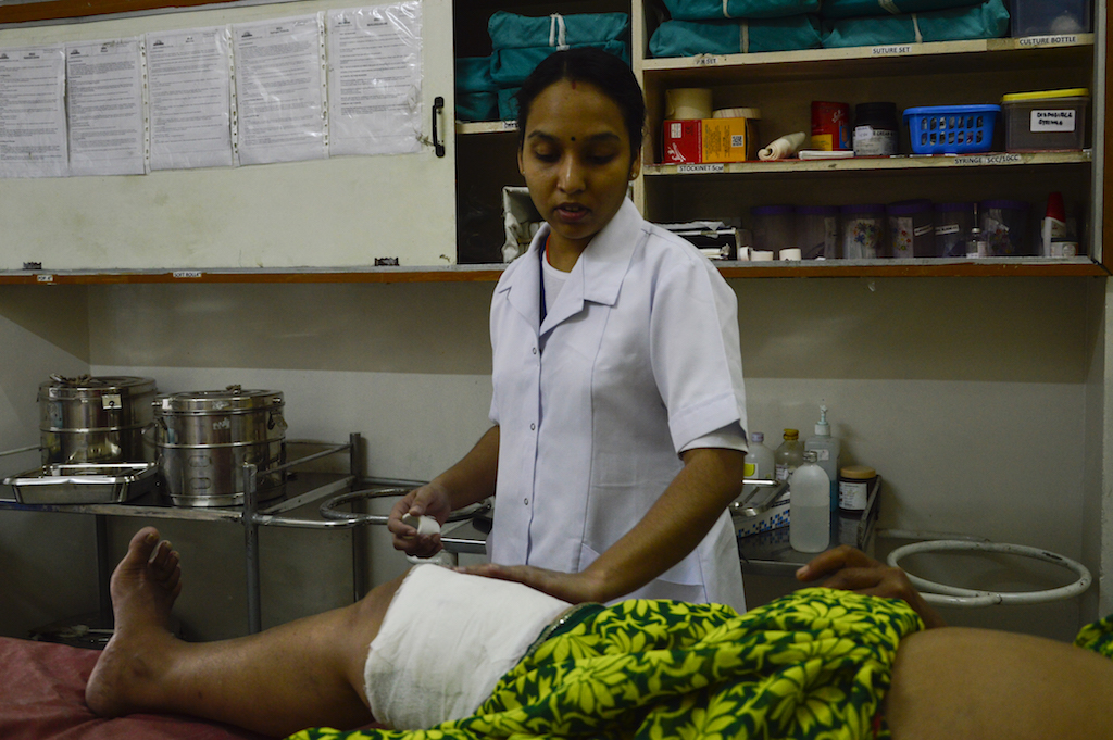 A nurse gives post operation treatment to a patient with Staphylococcus aureus infection. A nurse gives post operation treatment to a patient with Staphylococcus aureus infection.