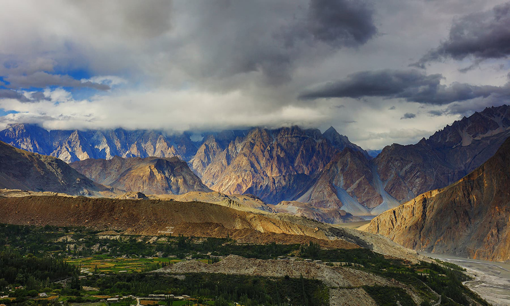 The last rays of the sun shining on Passu Cones in Gulmit village. The last rays of the sun shining on Passu Cones in Gulmit village.