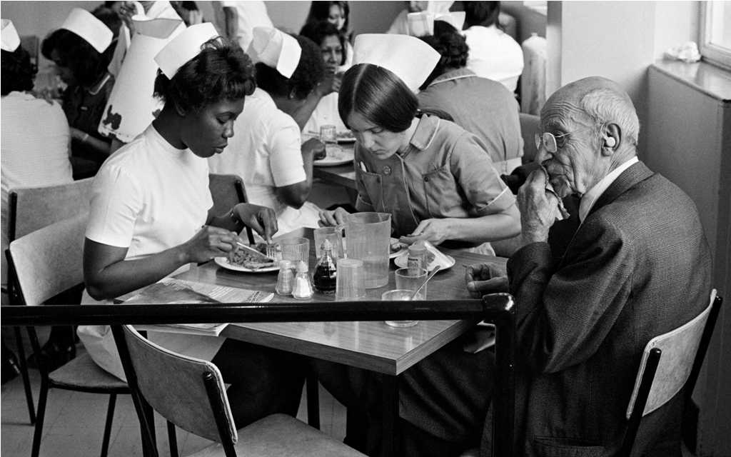 Nurses Eating Lunch, from the Migration Museum's '100 Images of Migration' exhibition © Peter Marlowe. Nurses Eating Lunch, from the Migration Museum's '100 Images of Migration' exhibition © Peter Marlowe.