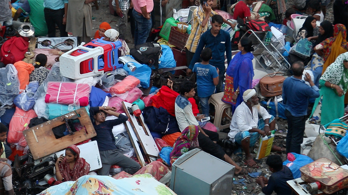 Residents of the gutted homes sit beside their belongings in a ground near the station. Photo: Omkar Phatak Residents of the gutted homes sit beside their belongings in a ground near the station. Photo: Omkar Phatak