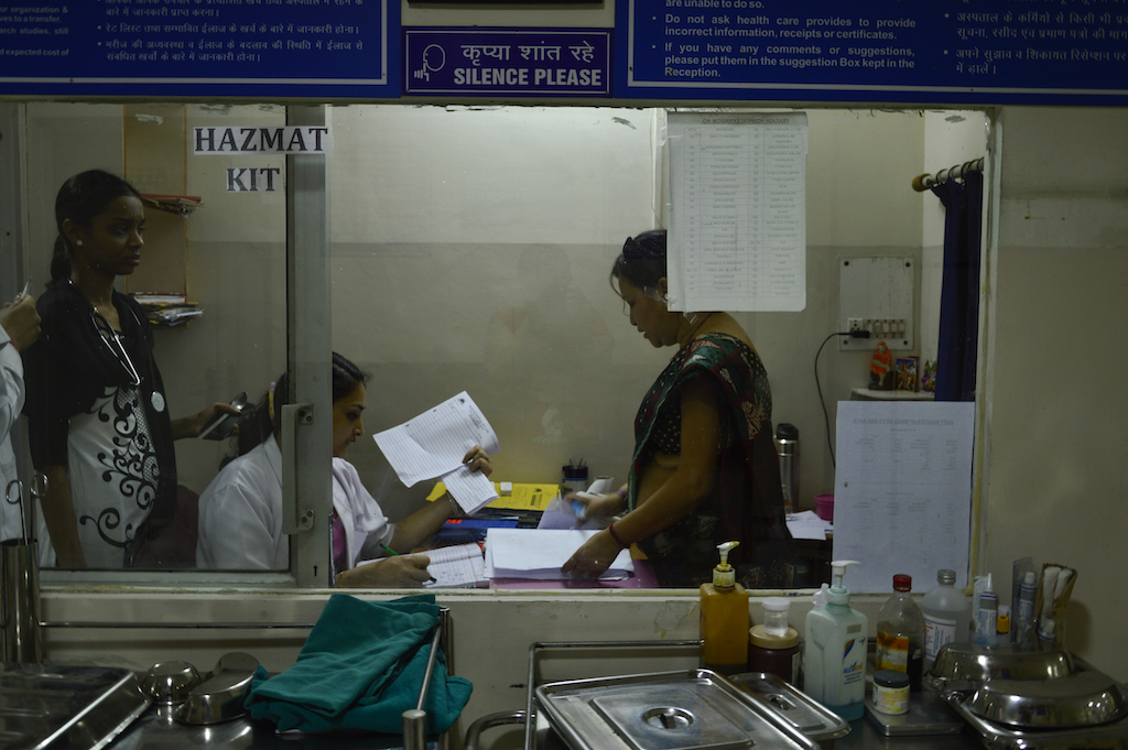 The nurse superintendent and doctors in the doctor duty room reviewing medical records. The nurse superintendent and doctors in the doctor duty room reviewing medical records.