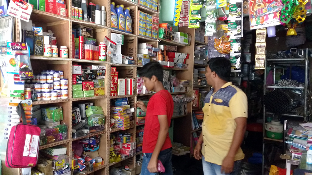 Pravin Gholap and his assistant search for their point of sale machine. Pravin Gholap and his assistant search for their point of sale machine.