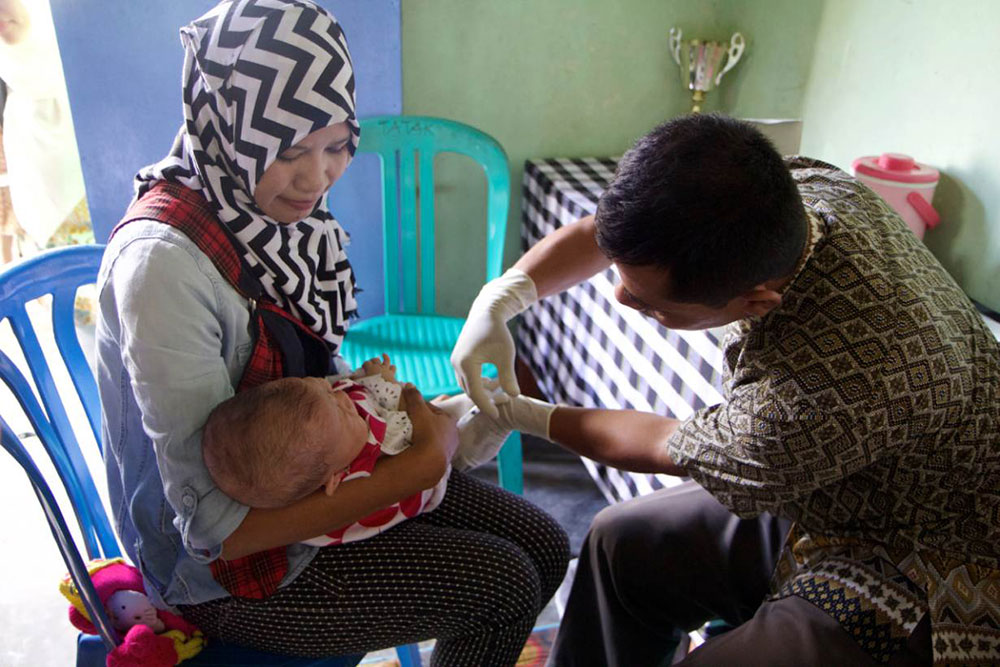 A doctor vaccinates a baby girl at a local health centre in Sengkol sub-district in central Lombok, east Indonesia, May 18, 2017. Photo credit: Thin Lei Win/Thomson Reuters Foundation A doctor vaccinates a baby girl at a local health centre in Sengkol sub-district in central Lombok, east Indonesia, May 18, 2017. Photo credit: Thin Lei Win/Thomson Reuters Foundation