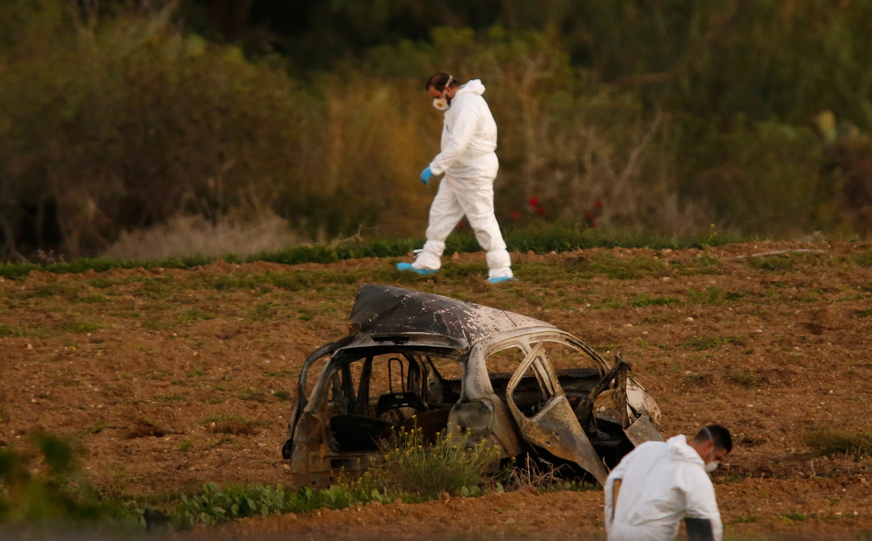 The bomb sent the car flying into a field. (Credit: Darrin Zammit Lupi/Reuters) The bomb sent the car flying into a field. (Credit: Darrin Zammit Lupi/Reuters)