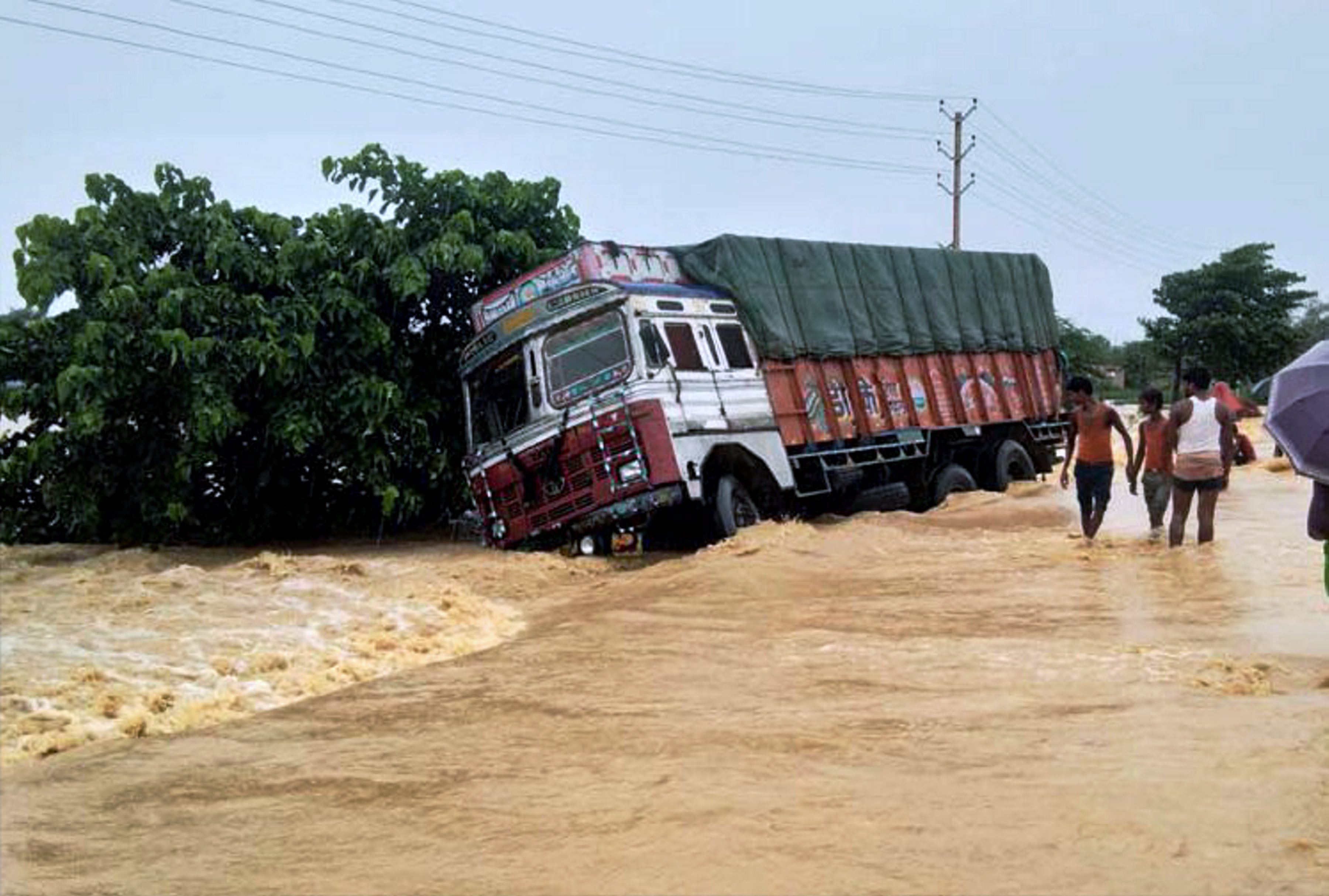 A truck drifts off the submerged NH-28 in Bihar's East Champaran district. (Credit: PTI) A truck drifts off the submerged NH-28 in Bihar's East Champaran district. (Credit: PTI)