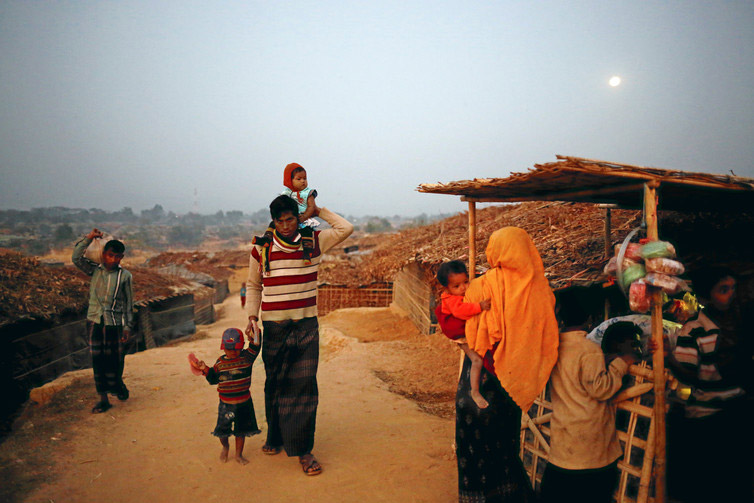 Rohingya refugees return to their makeshift home at Kutupalang Unregistered Refugee Camp, Bangladesh. ( Photo credit: Mohammad Ponir Hossain / Reuters ) Rohingya refugees return to their makeshift home at Kutupalang Unregistered Refugee Camp, Bangladesh. ( Photo credit: Mohammad Ponir Hossain / Reuters )