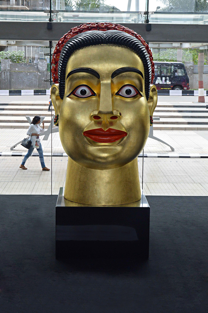 Ravinder Reddy’s head sculptures have become some of his most iconic pieces. ‘Devi’, with her unwavering gaze, protruding lips and golden skin, is a quintessential example of his work. Ravinder Reddy’s head sculptures have become some of his most iconic pieces. ‘Devi’, with her unwavering gaze, protruding lips and golden skin, is a quintessential example of his work.