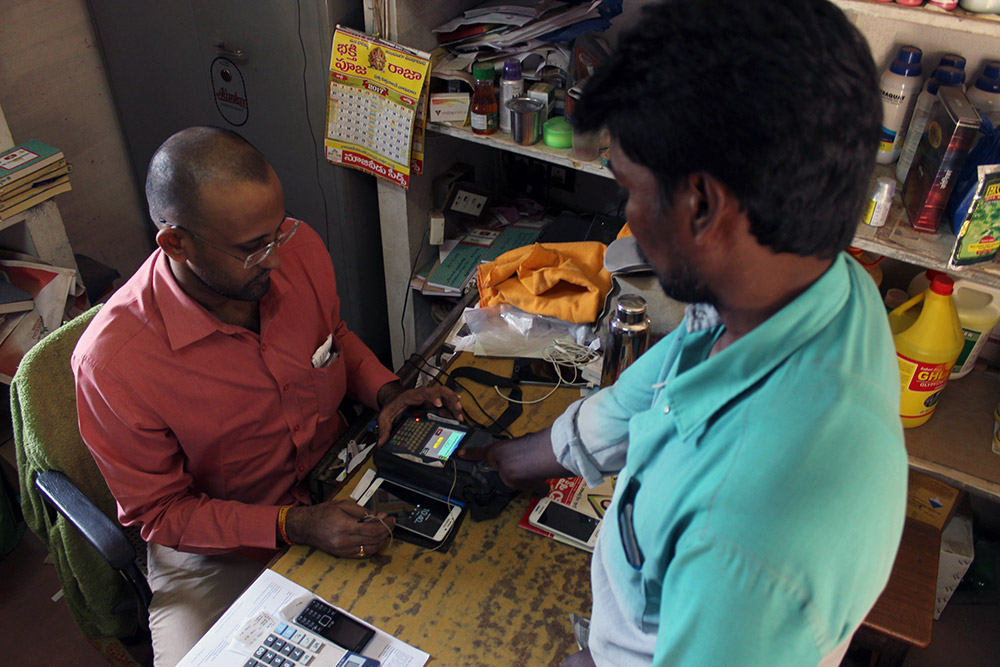 V Sreenivasa Rao is an auto driver from P Nainvaram village in Krishna. He buys fertiliser for most of the farmers in his village by using his biometrics and transports it in his auto. He charges Rs 20 per bag as the transportation charge. Photo by Kumar Sambhav V Sreenivasa Rao is an auto driver from P Nainvaram village in Krishna. He buys fertiliser for most of the farmers in his village by using his biometrics and transports it in his auto. He charges Rs 20 per bag as the transportation charge. Photo by Kumar Sambhav