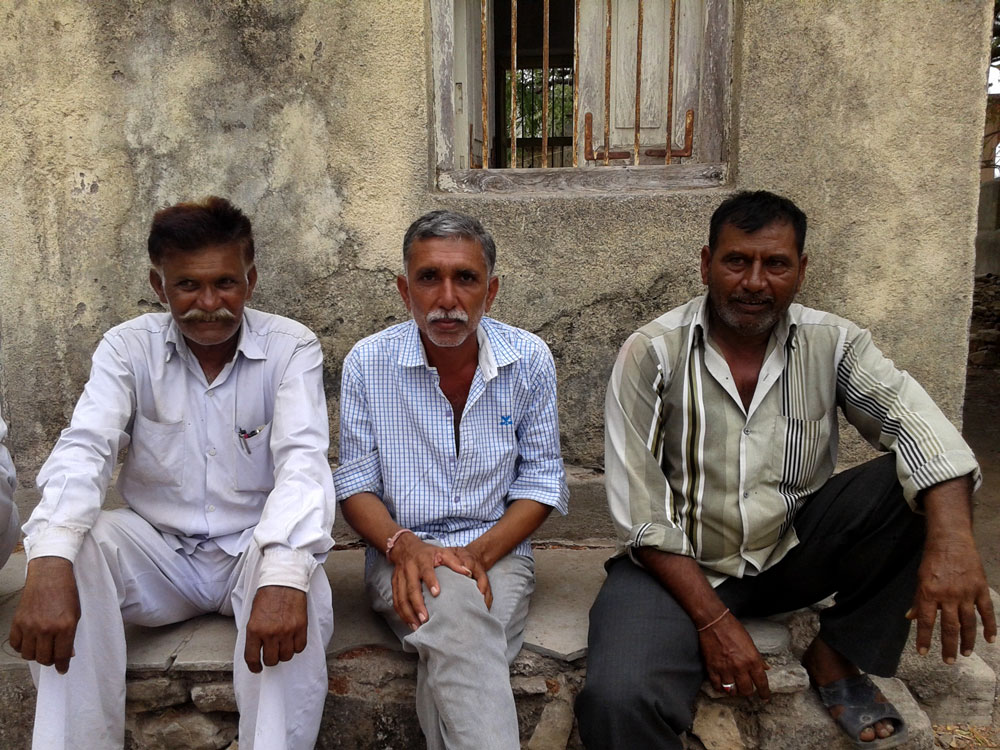 Bhimabhai Chhaiya (right) and other villagers of Sumri were denied food rations when thumbprint scanners stopped working. Bhimabhai Chhaiya (right) and other villagers of Sumri were denied food rations when thumbprint scanners stopped working.