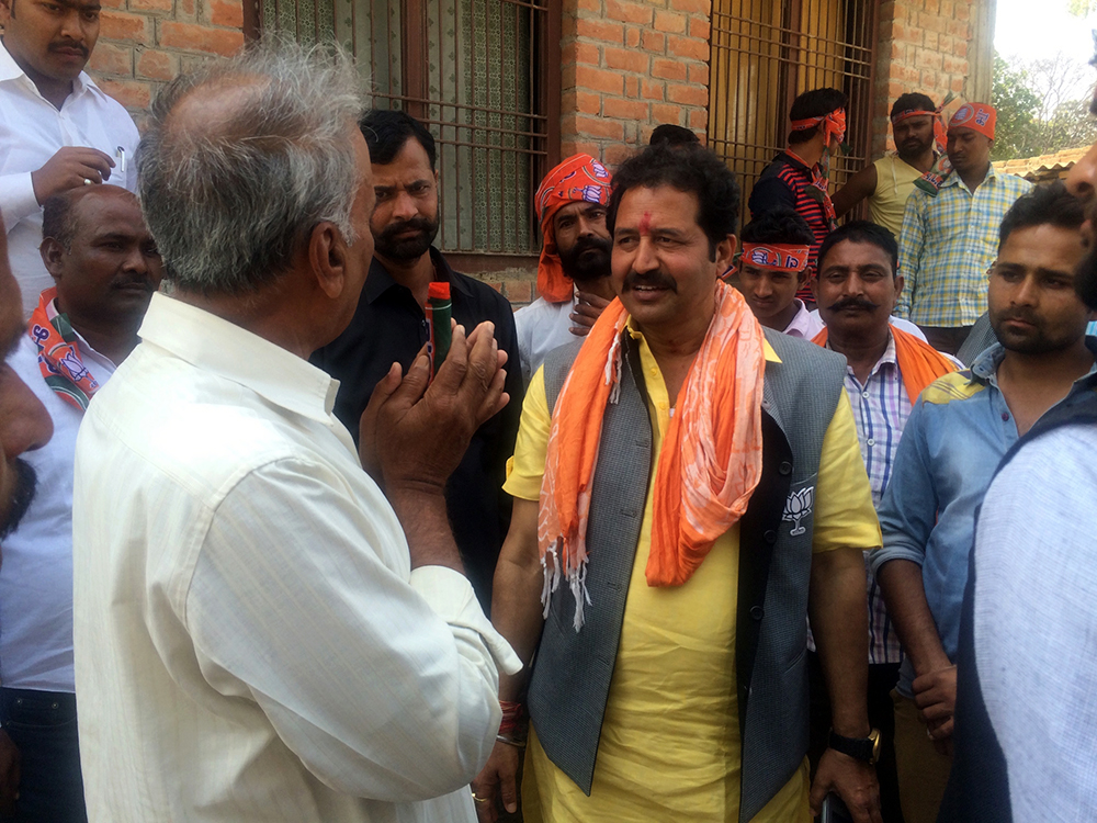 Satish Singh taking the advice of an older man. Satish Singh taking the advice of an older man.
