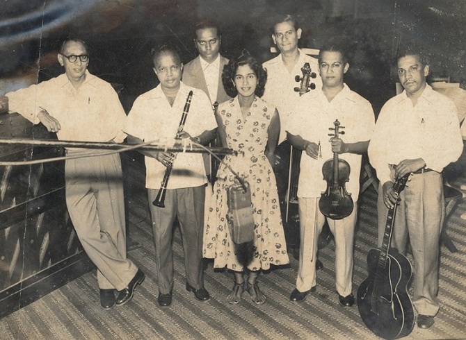 Anthony Gonsalves (back row, left) in a recording studio with other musicians, including the pianist Lucila Pacheco. Anthony Gonsalves (back row, left) in a recording studio with other musicians, including the pianist Lucila Pacheco.