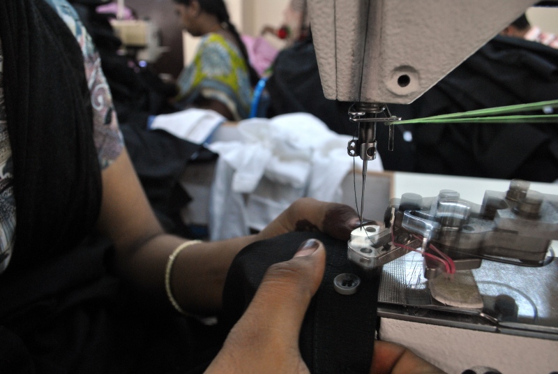 Workers must fix 80-100 buttons an hour, never taking their eye off the needle for eight hours, except for a 30-minute lunch break. (Photo credit: Rohini Mohan) Workers must fix 80-100 buttons an hour, never taking their eye off the needle for eight hours, except for a 30-minute lunch break. (Photo credit: Rohini Mohan)