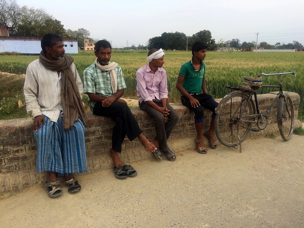 Dalit men ruminate over the results. Dalit men ruminate over the results.