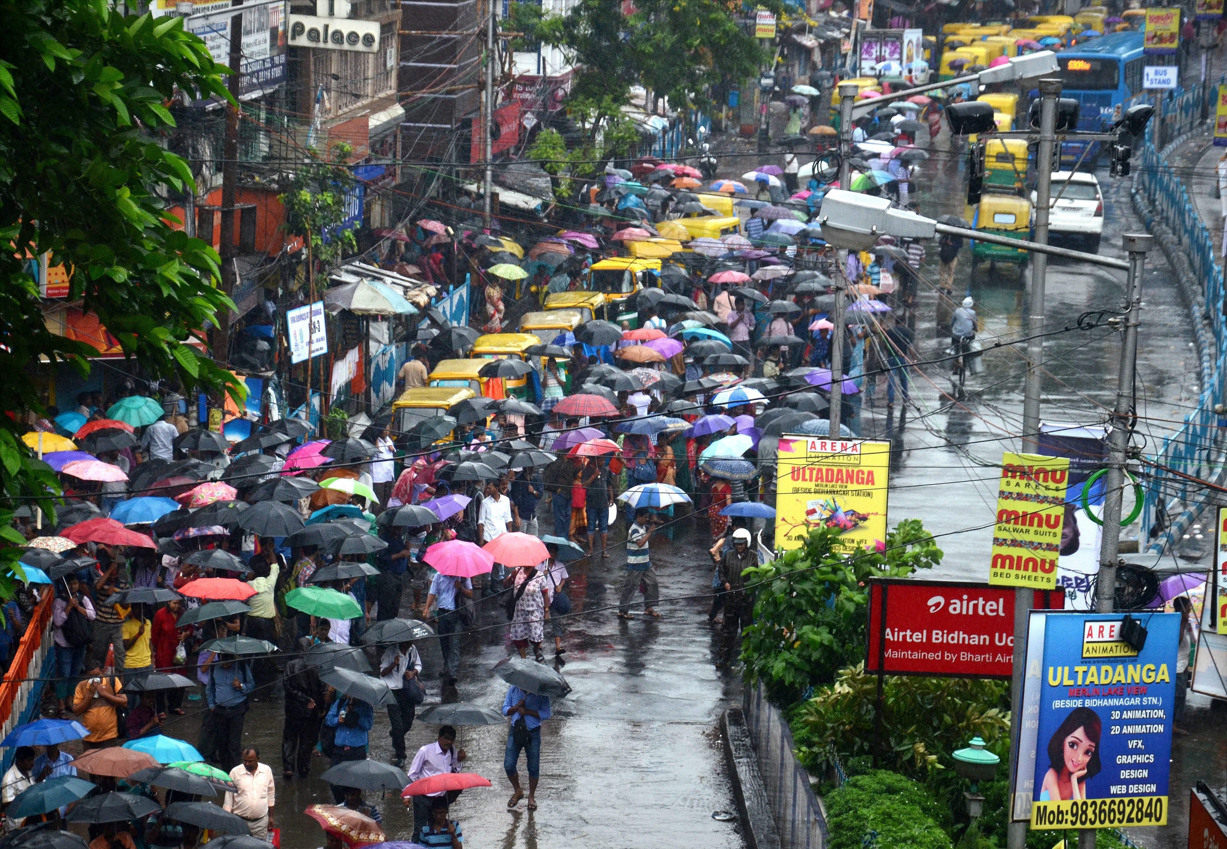 After a spell of heavy rain, commuters queue up for buses and taxis in Kolkata. (PTI photo) After a spell of heavy rain, commuters queue up for buses and taxis in Kolkata. (PTI photo)