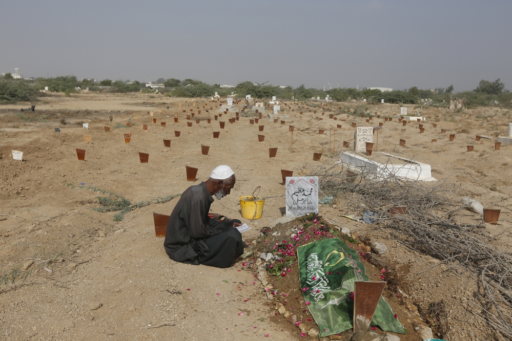 A mourner at the grave of his deceased son, previously missing but now traced to the Edhi Foundation graveyard. (Photo: Akthar Soomro/Reuters) A mourner at the grave of his deceased son, previously missing but now traced to the Edhi Foundation graveyard. (Photo: Akthar Soomro/Reuters)