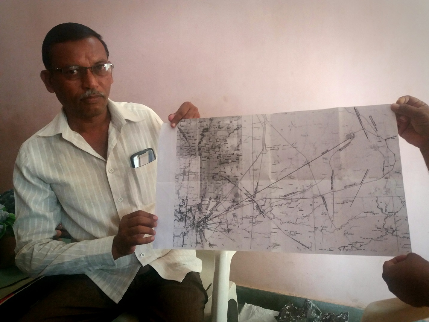 Ashok Patel displays a map of the GETCO power line route running through his farmland. Ashok Patel displays a map of the GETCO power line route running through his farmland.