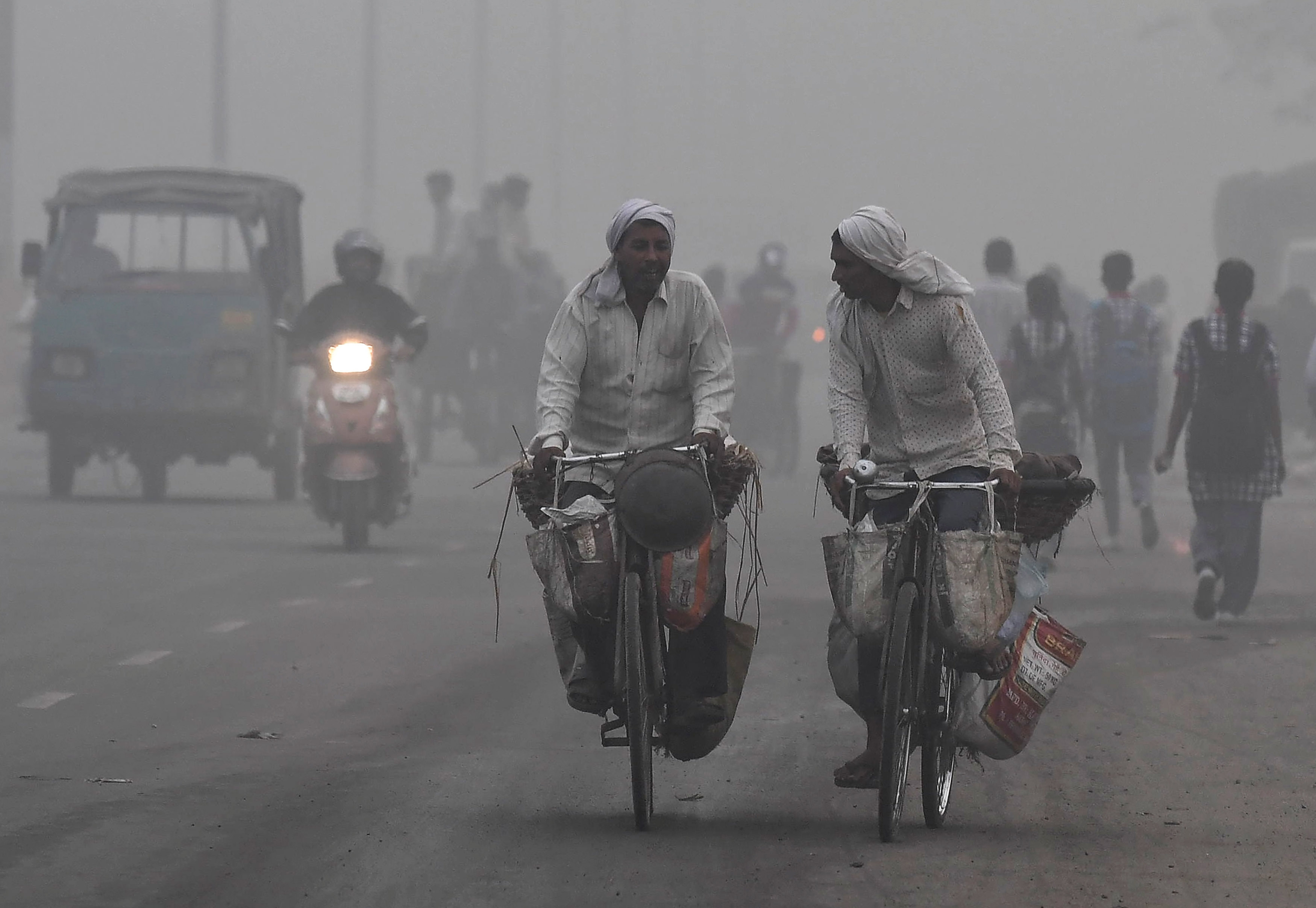 Cyclists and motorists make their way through the smog in New Delhi (AFP) Cyclists and motorists make their way through the smog in New Delhi (AFP)