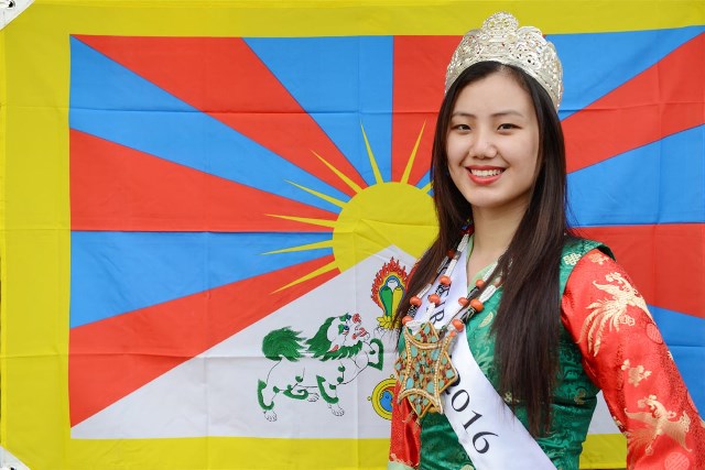 Miss Tibet 2016 Tenzing Sangnyi posing before the Tibetan flag. Miss Tibet 2016 Tenzing Sangnyi posing before the Tibetan flag.
