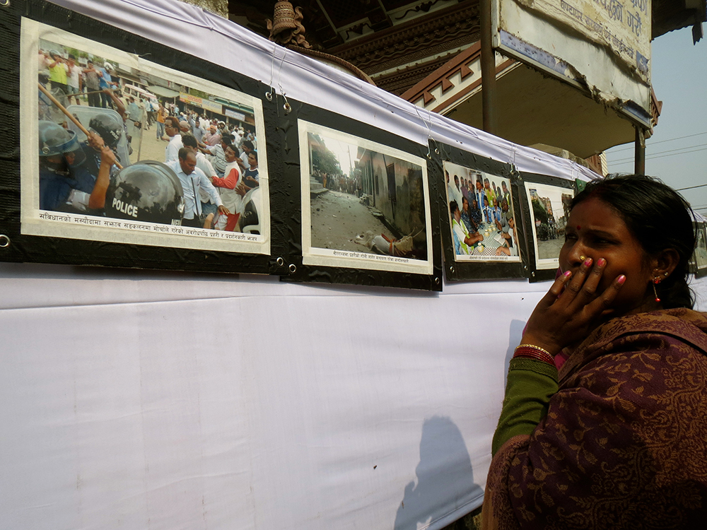 Eenar Jyoti from Chaukiaberia village in Parsa looks at photographs from the protests. Photo: Anumeha Yadav Eenar Jyoti from Chaukiaberia village in Parsa looks at photographs from the protests. Photo: Anumeha Yadav