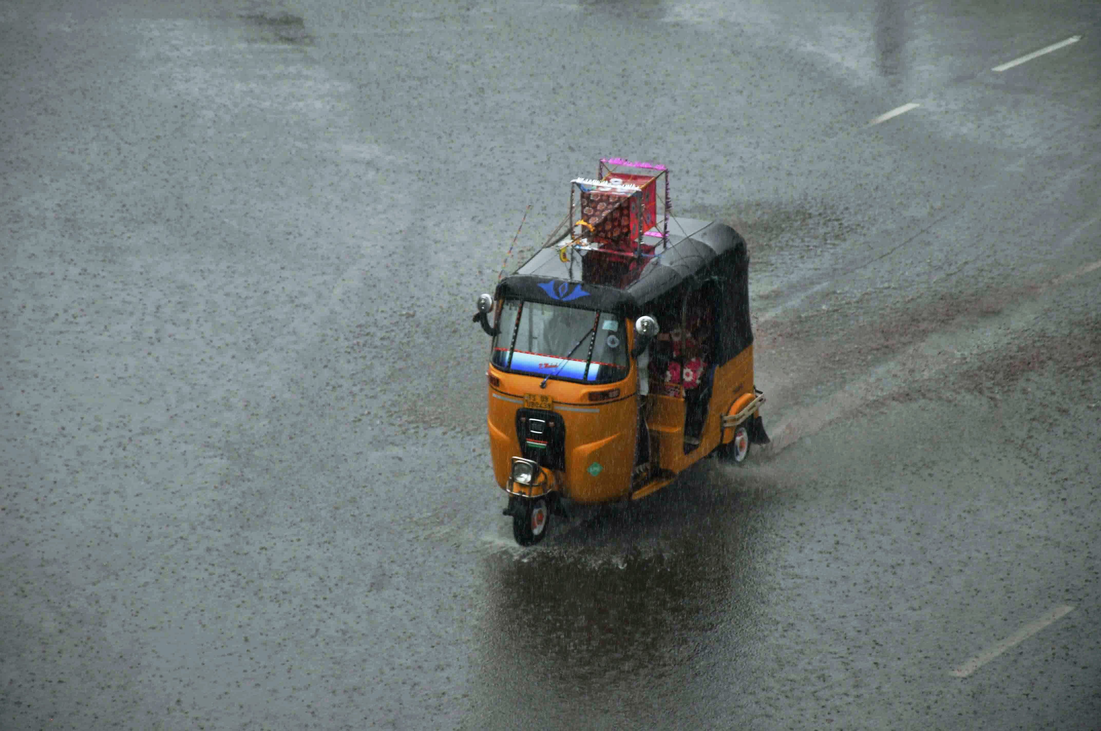 An auto rushes through flooded street in Bhubaneshwar. (Credit: PTI) An auto rushes through flooded street in Bhubaneshwar. (Credit: PTI)