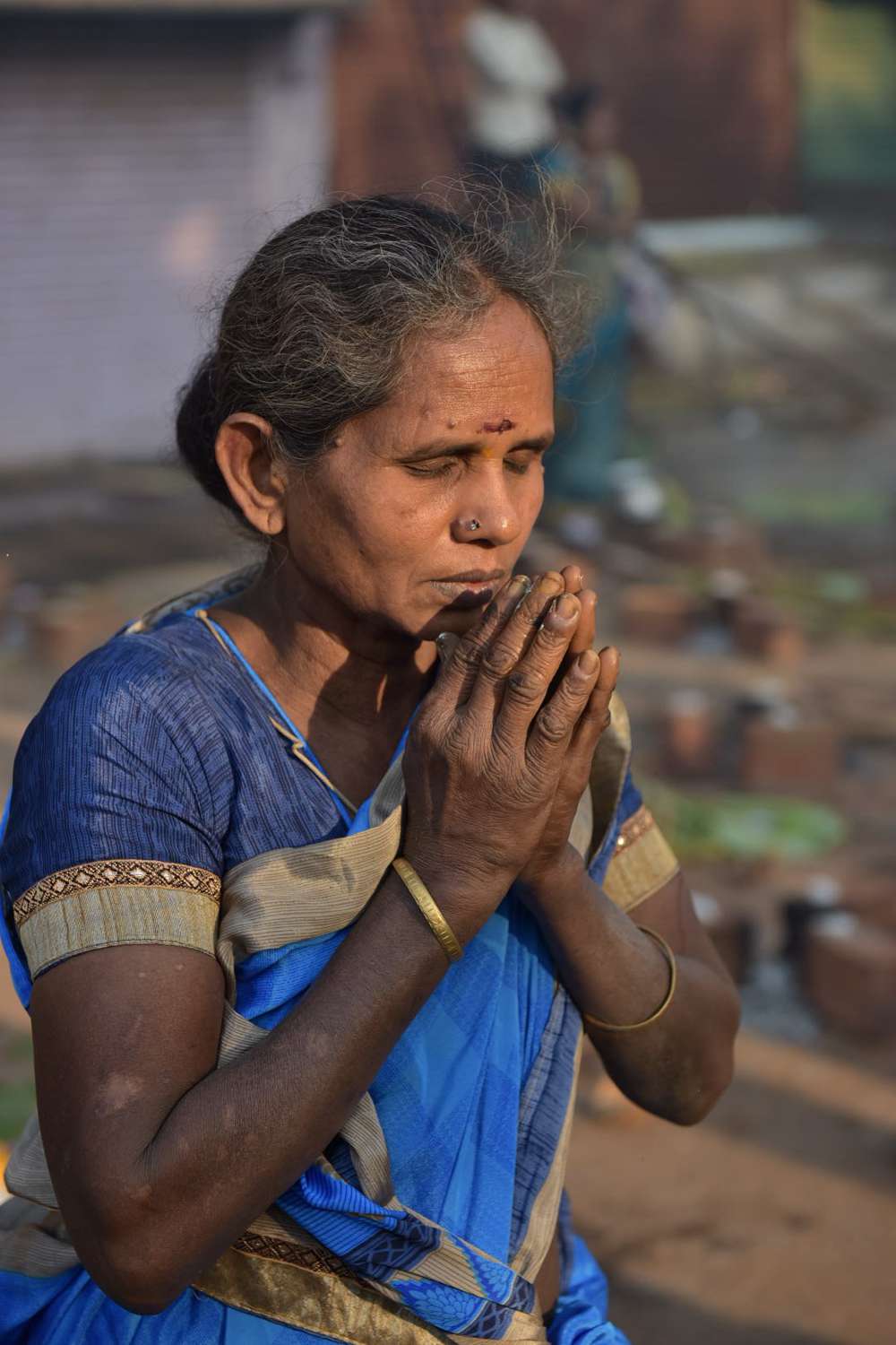 A woman prays to the rising sun. A woman prays to the rising sun.