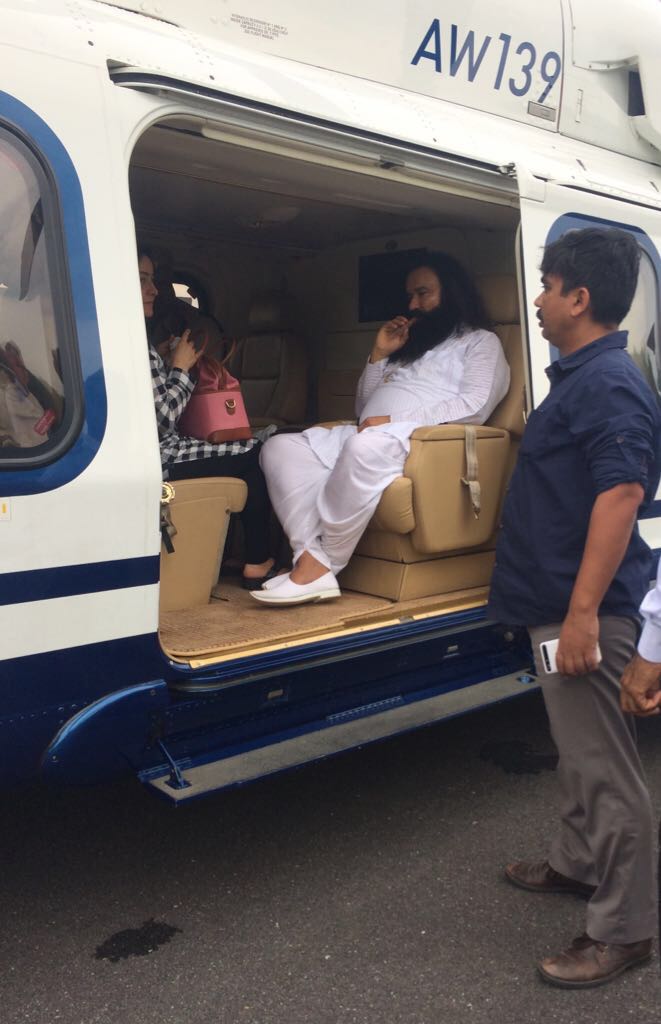 This image shows Gurmeet Ram Rahim Singh with his adopted daughter Honeypreet Insan on board an AgustaWestland helicopter. This image shows Gurmeet Ram Rahim Singh with his adopted daughter Honeypreet Insan on board an AgustaWestland helicopter.