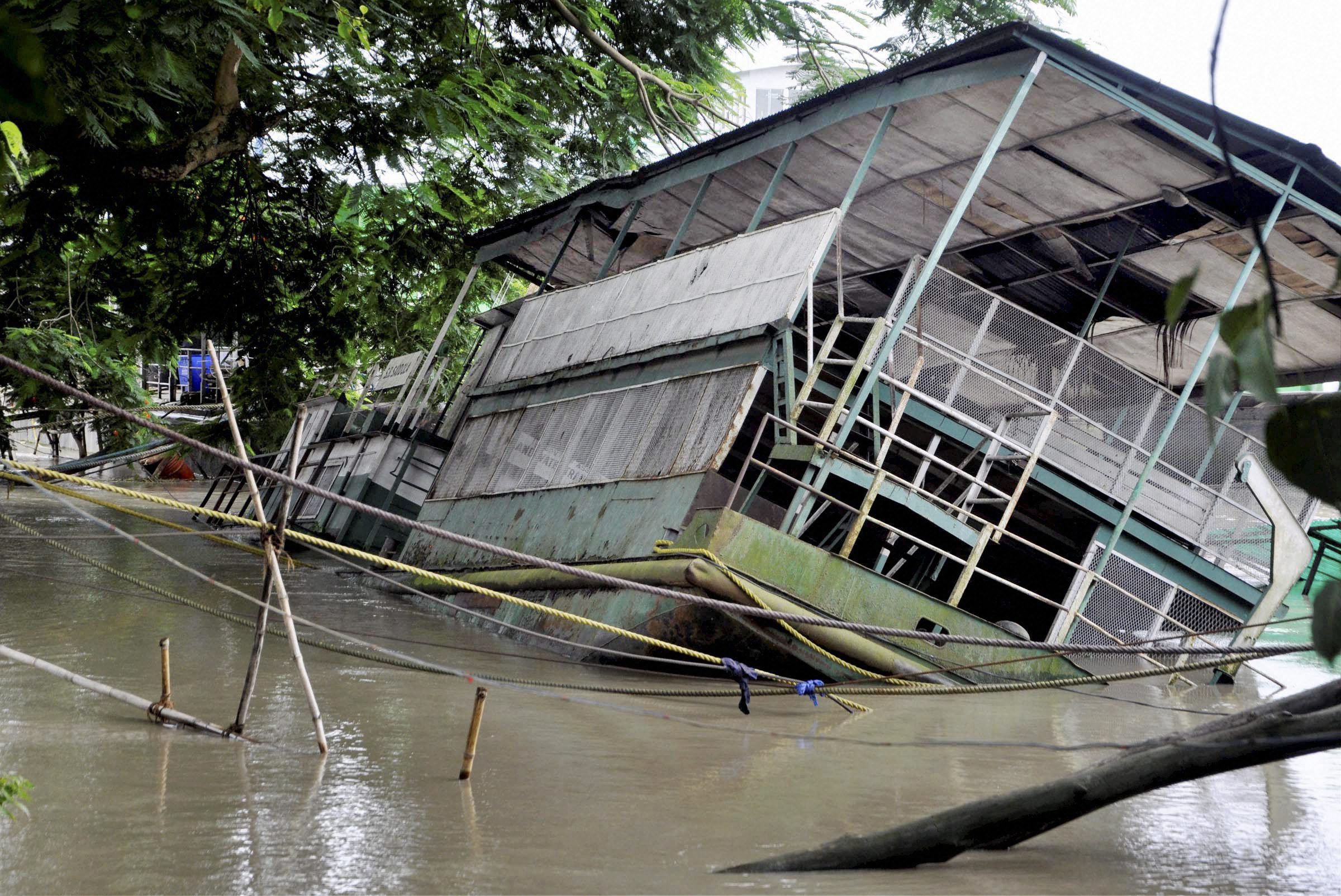 The Rajaduwar Ghat in Guwahati submerged by the flooded Brahmaputra river in on Sunday. PTI Photo. The Rajaduwar Ghat in Guwahati submerged by the flooded Brahmaputra river in on Sunday. PTI Photo.