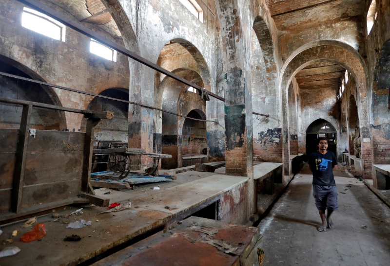 A man walks inside a closed mutton market in Lucknow in March. (Photo credit: Pawan Kumar/ Reuters). A man walks inside a closed mutton market in Lucknow in March. (Photo credit: Pawan Kumar/ Reuters).