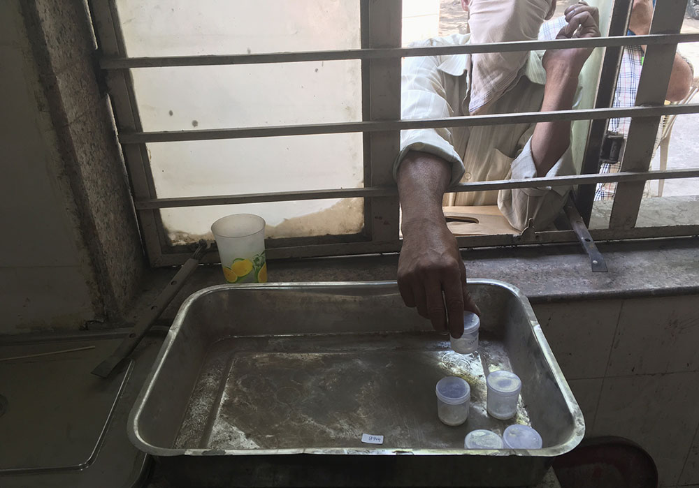 Patient giving his sputum sample in Delhi's Chandani Chowk's Chest Clinic. Patient giving his sputum sample in Delhi's Chandani Chowk's Chest Clinic.