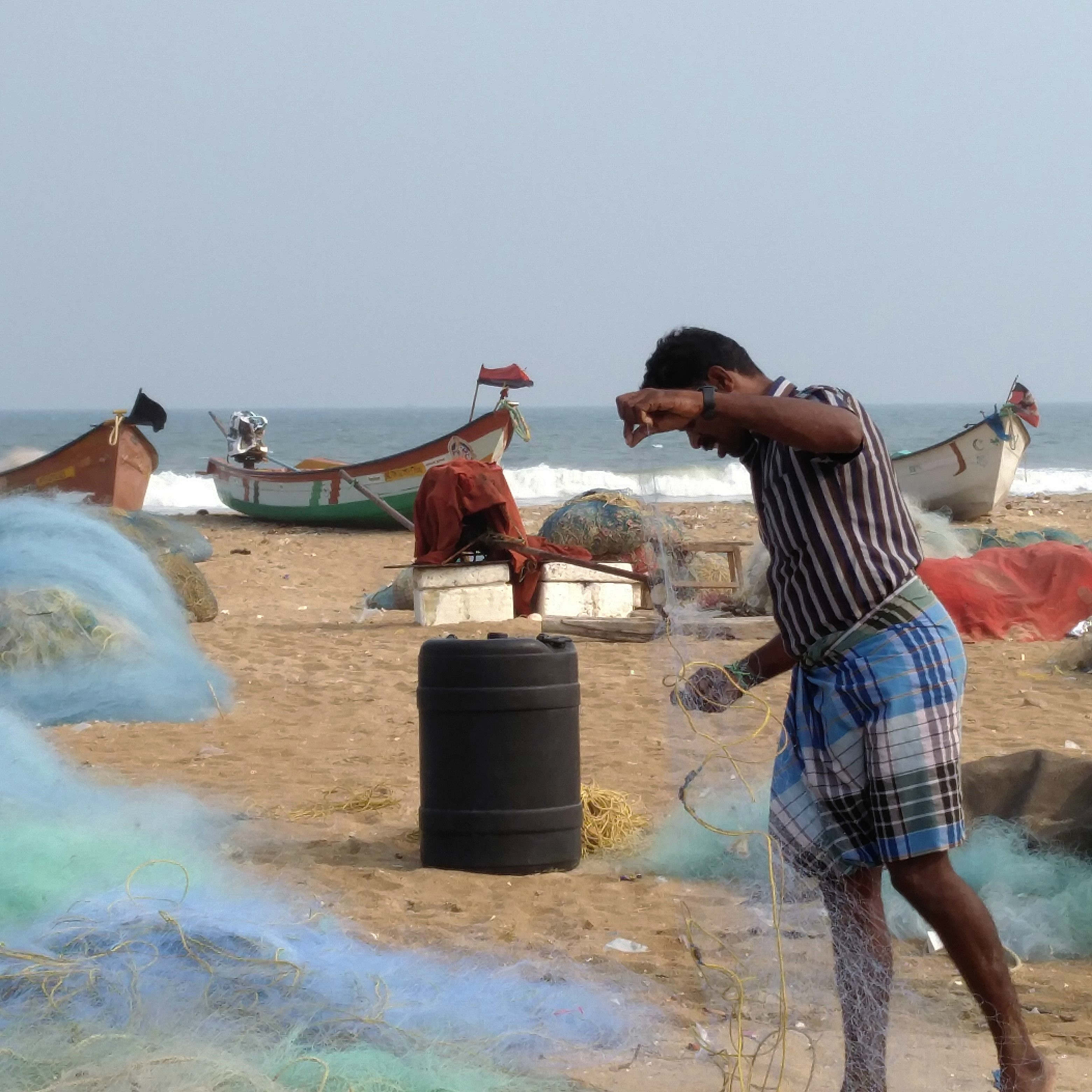 An artisanal fisherman folds his net on Marina beach in Chennai. (Photo credit: Vinita Govindarajan). An artisanal fisherman folds his net on Marina beach in Chennai. (Photo credit: Vinita Govindarajan).