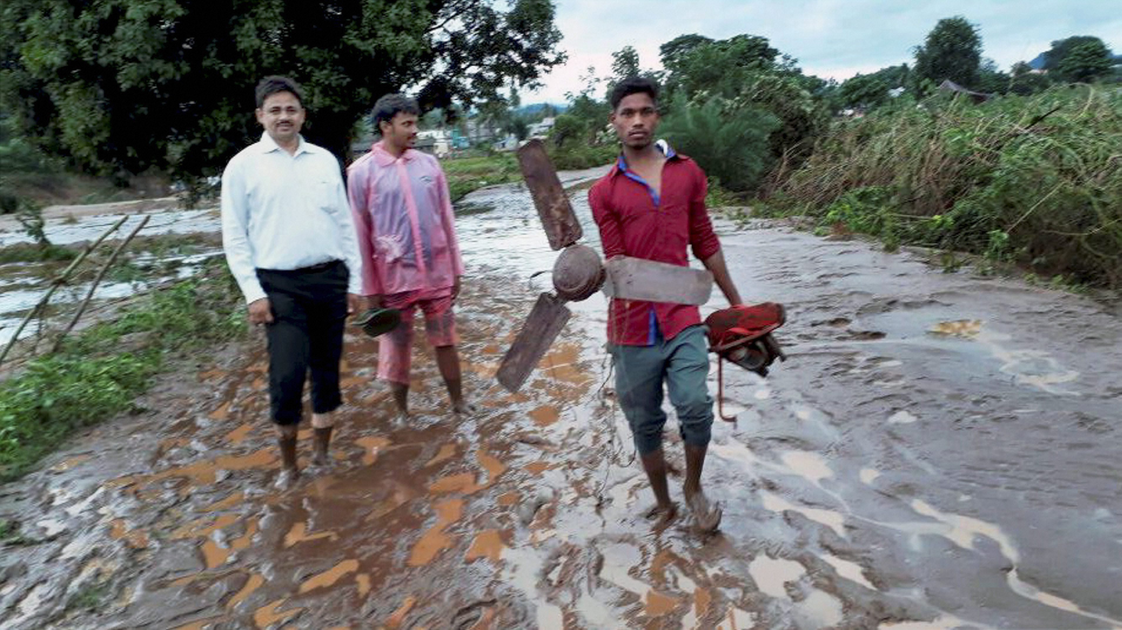 People walk through rain-lashed muddy streets in Kalyansingpur village in Odisha's Rayagada distrcit. (Credit: PTI) People walk through rain-lashed muddy streets in Kalyansingpur village in Odisha's Rayagada distrcit. (Credit: PTI)