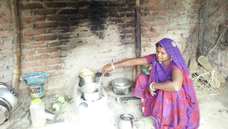 Sona Devi cooks on her wood stove. (Photo credit: Dhirendra K Jha). Sona Devi cooks on her wood stove. (Photo credit: Dhirendra K Jha).