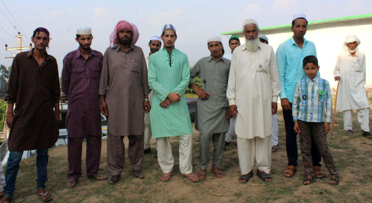 Residents of Drana-Basuni village gather outside the mosque after Friday afternoon prayers. Credit: Rahi Kapoor Residents of Drana-Basuni village gather outside the mosque after Friday afternoon prayers. Credit: Rahi Kapoor