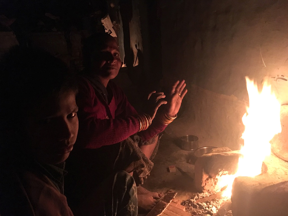 Andhera Gher slum residents keeping themselves warm by a wood-fueled fire on a cold November night. Photo credit: Menaka Rao. Andhera Gher slum residents keeping themselves warm by a wood-fueled fire on a cold November night. Photo credit: Menaka Rao.