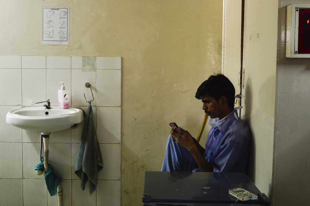Tired from a whole days work, a ward boy takes time to call home. Tired from a whole days work, a ward boy takes time to call home.