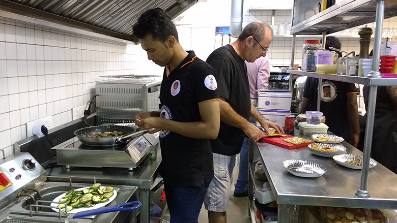 Anil Kurup and Carlos Perez at work in the café's kitchen. Anil Kurup and Carlos Perez at work in the café's kitchen.