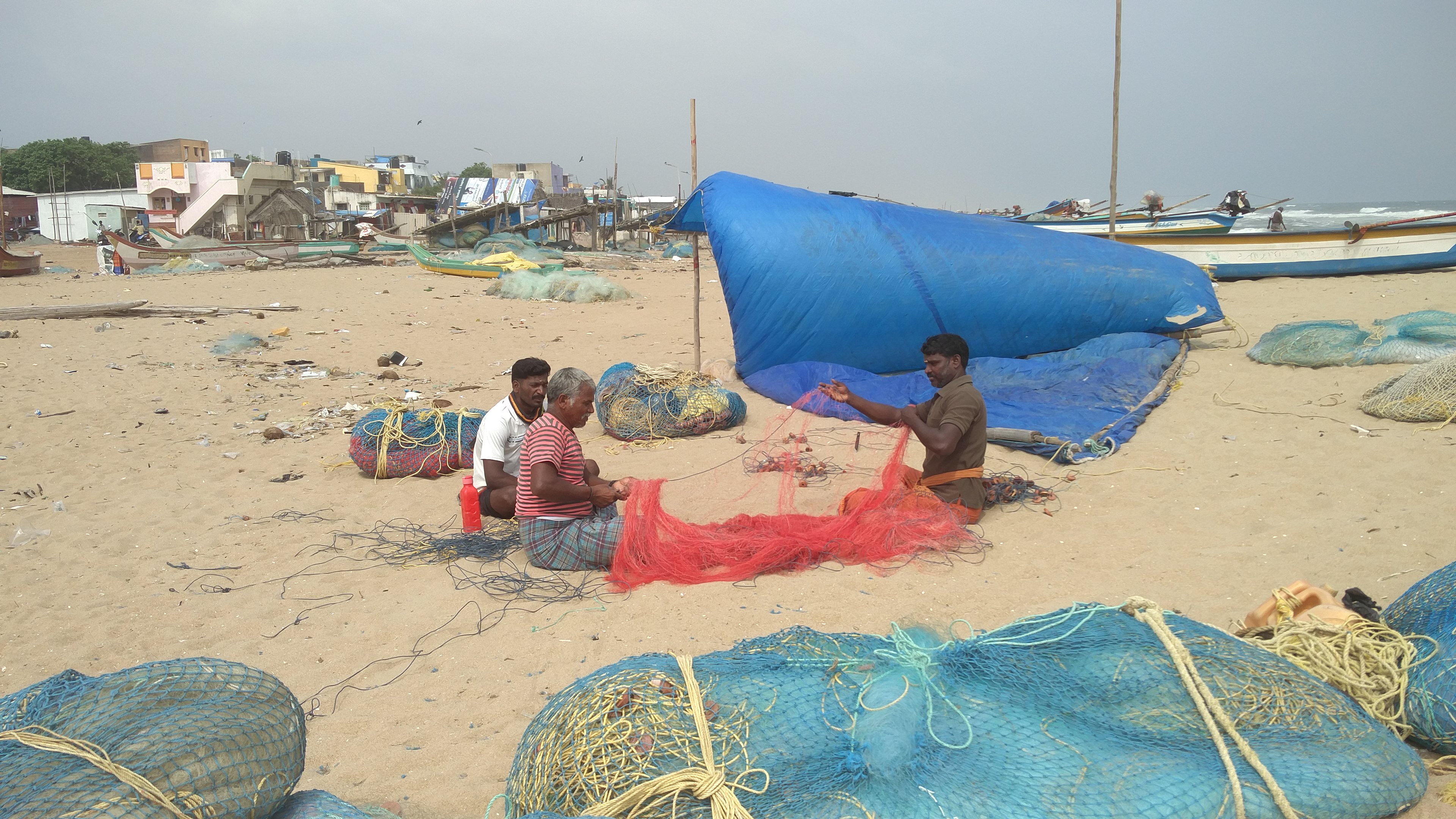 Fisherfolk of Urur Olcott Kuppam village mend their nets. (Credit: Vinita Govindarajan) Fisherfolk of Urur Olcott Kuppam village mend their nets. (Credit: Vinita Govindarajan)