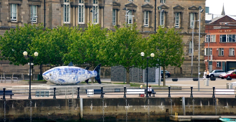 A ceramic mosaic sculpture by artist John Kindness that alludes to the mythological salmon of knowledge stands on Donegall Quay in Belfast, Northern Ireland. (Photo credit: William Murphy/Flickr/ CC BY-SA 2.0). A ceramic mosaic sculpture by artist John Kindness that alludes to the mythological salmon of knowledge stands on Donegall Quay in Belfast, Northern Ireland. (Photo credit: William Murphy/Flickr/ CC BY-SA 2.0).