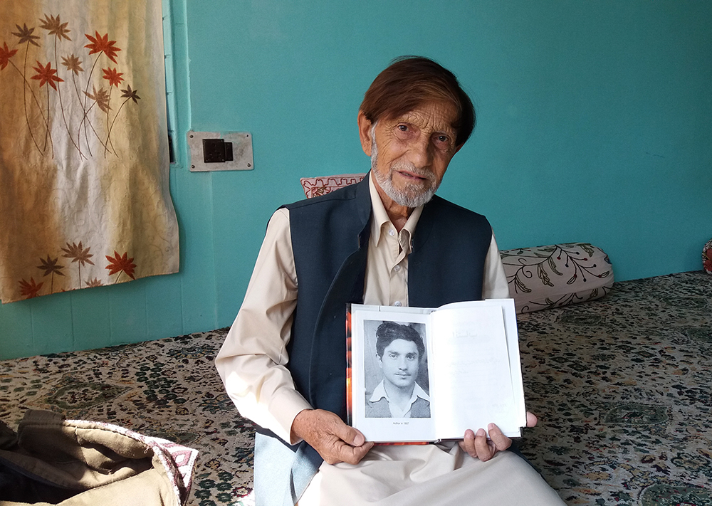 Khaliq Parvez holds up a picture of himself as a young man. Photo credit: Ipsita Chakravatry. Khaliq Parvez holds up a picture of himself as a young man. Photo credit: Ipsita Chakravatry.