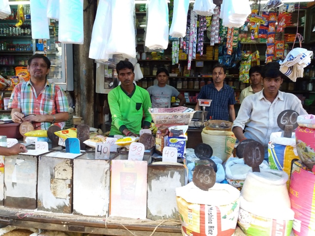 Grocer Ajit Kumar with the daily-wage delivery boys who work for him. Grocer Ajit Kumar with the daily-wage delivery boys who work for him.