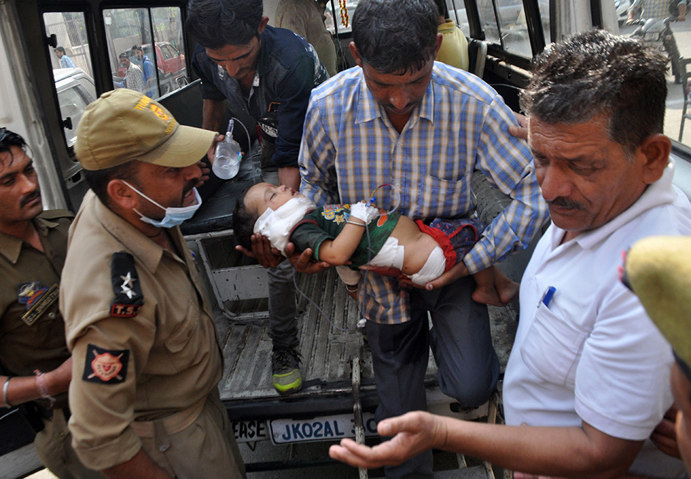 Indian volunteers and officials carry two-and-a half-year-old Pari into the Government Medical College Hospital in Jammu on November 1, after he was injured in cross-border shelling. Credit: STR/AFP Indian volunteers and officials carry two-and-a half-year-old Pari into the Government Medical College Hospital in Jammu on November 1, after he was injured in cross-border shelling. Credit: STR/AFP